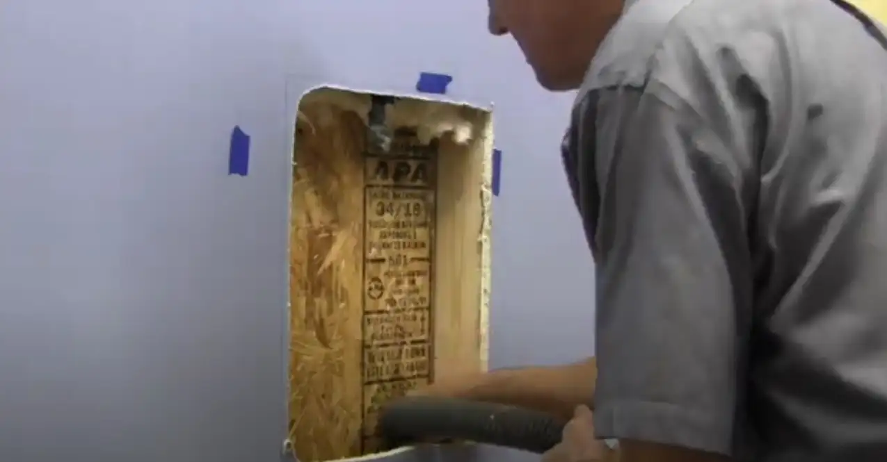 Vidcap of cutting rough opening in drywall